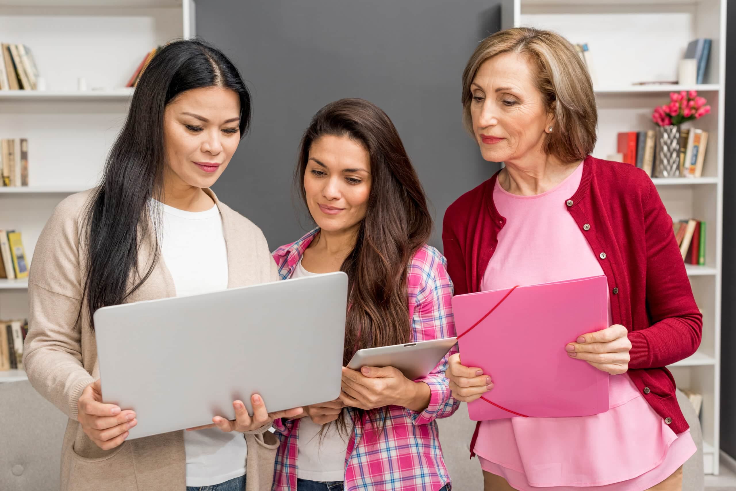 Women collaborating on laptops
